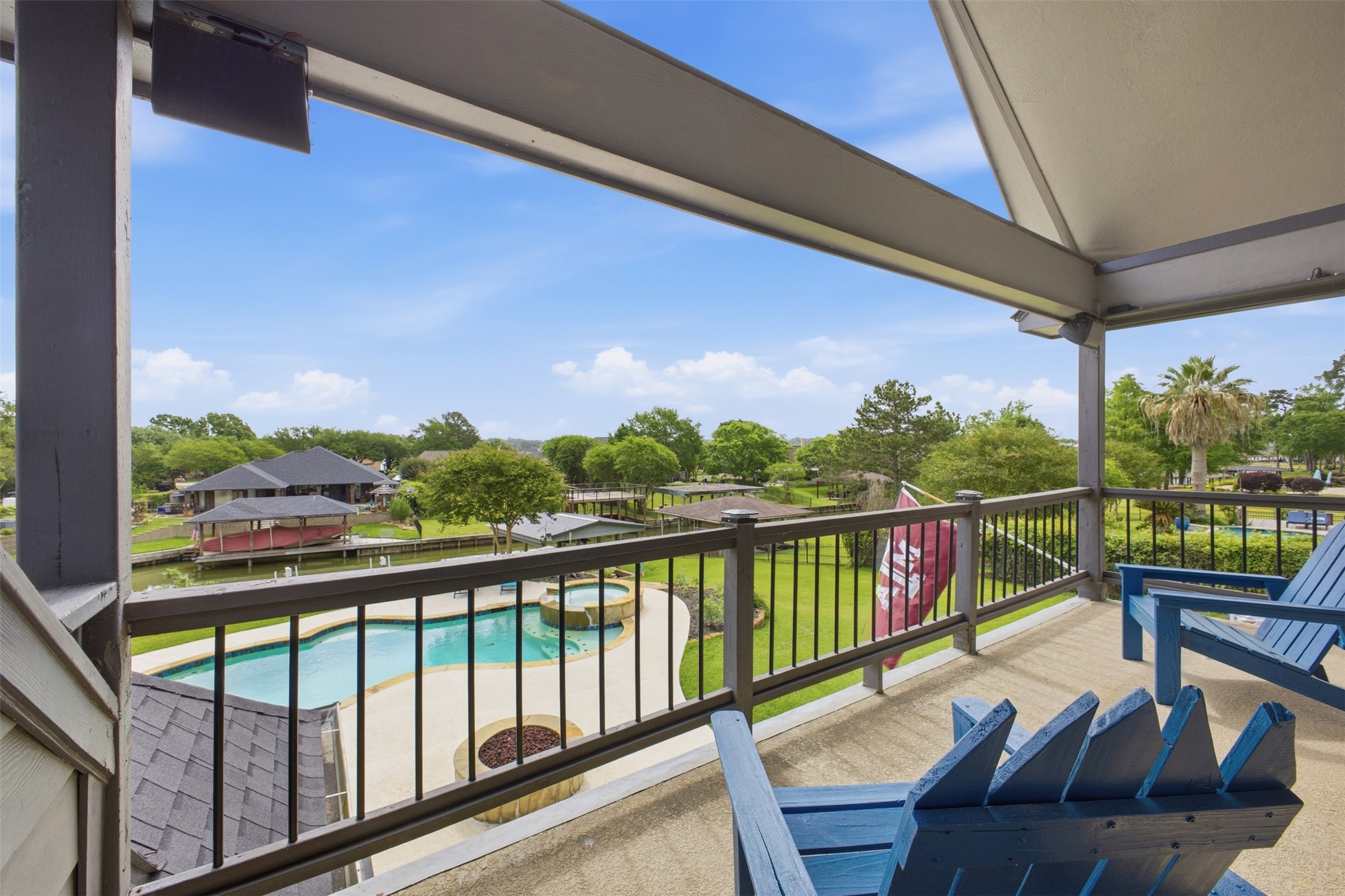 12710 Aries Loop Willis, TX 77318 - Photo 32 of 40 Covered outdoor balcony with a railing overlooking a swimming pool and a landscaped yard