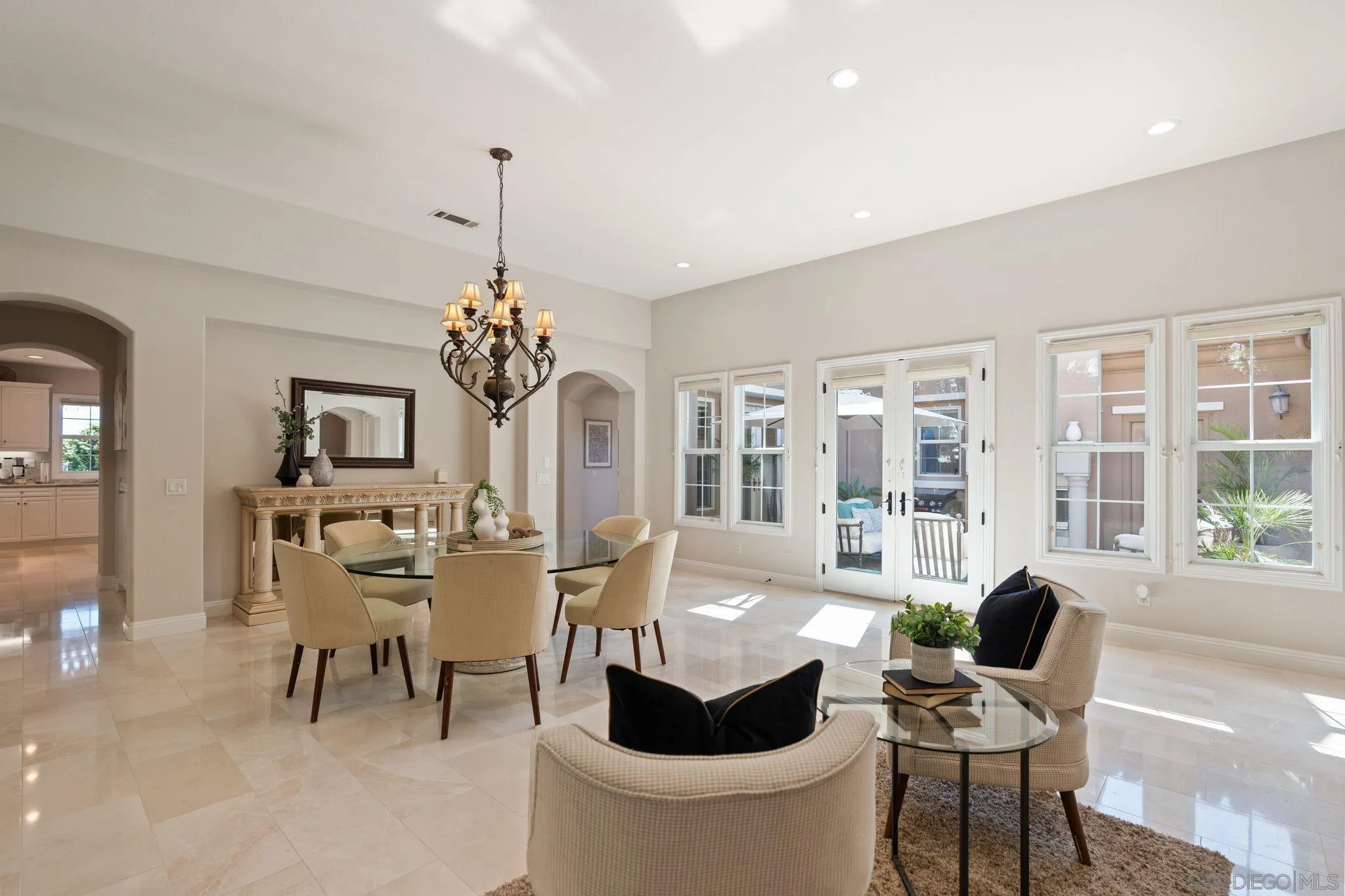 15583 Rising River Place South San Diego, CA 92127 - Photo 14 of 61 a dining room with furniture a chandelier and wooden floor