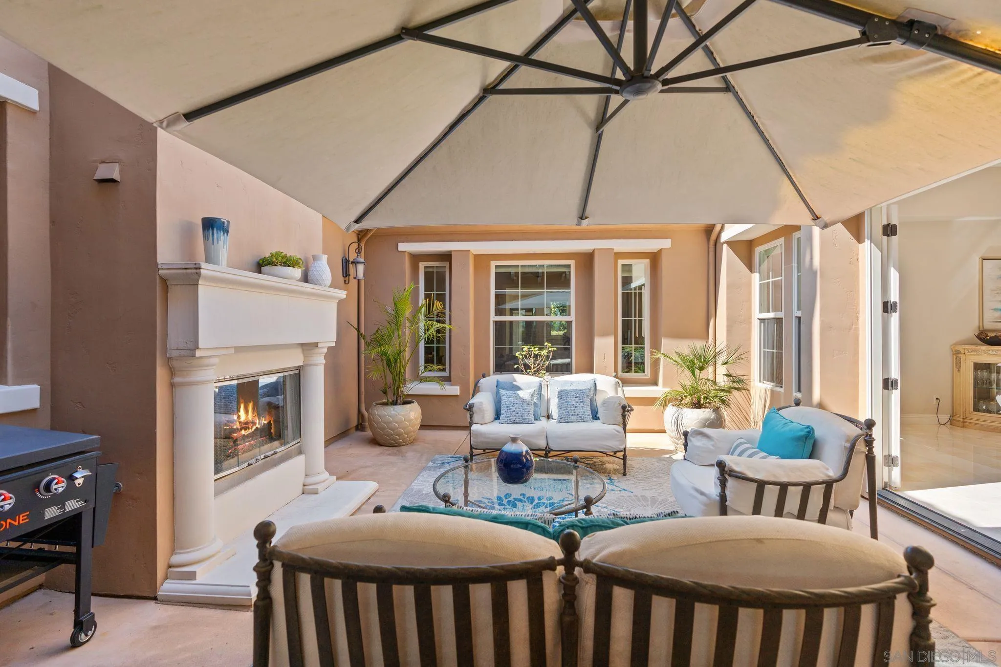 15583 Rising River Place South San Diego, CA 92127 - Photo 16 of 61 a living room with fireplace furniture and a large window