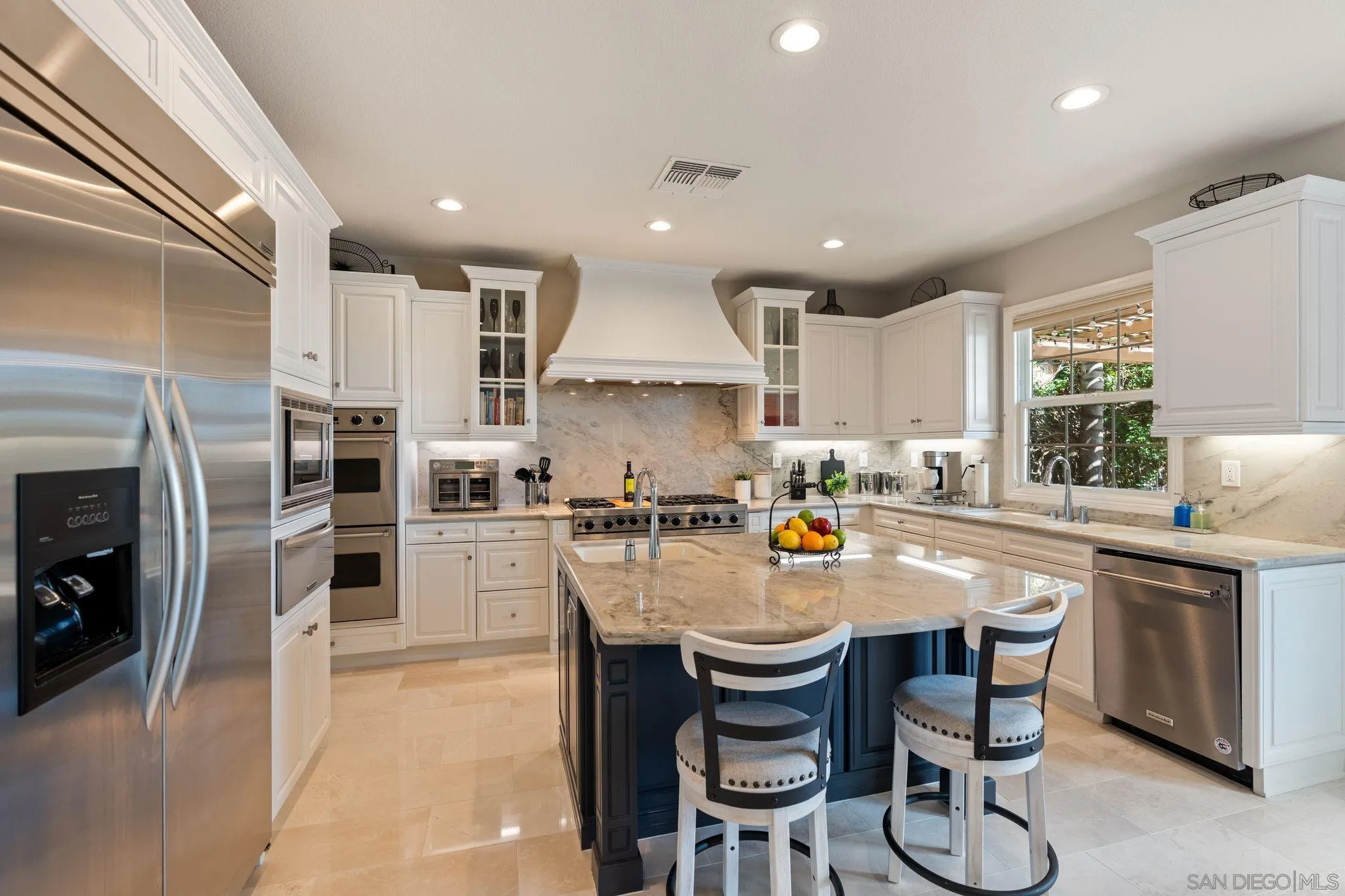 15583 Rising River Place South San Diego, CA 92127 - Photo 18 of 61 a kitchen with stainless steel appliances granite countertop a table chairs sink refrigerator and cabinets