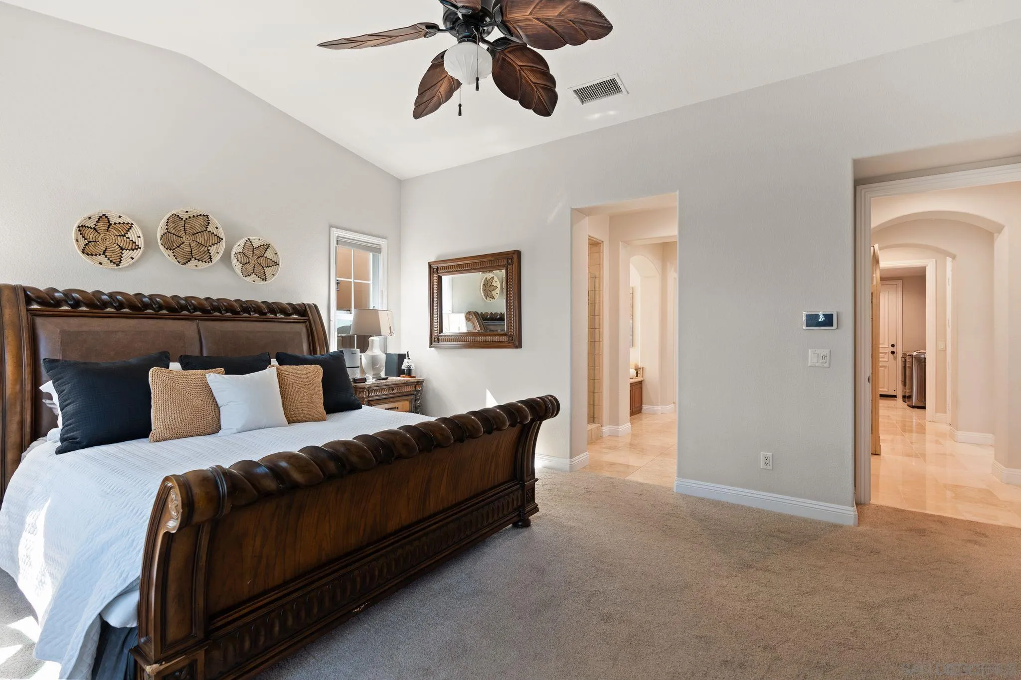 15583 Rising River Place South San Diego, CA 92127 - Photo 29 of 61 a bedroom with a bed and a chandelier