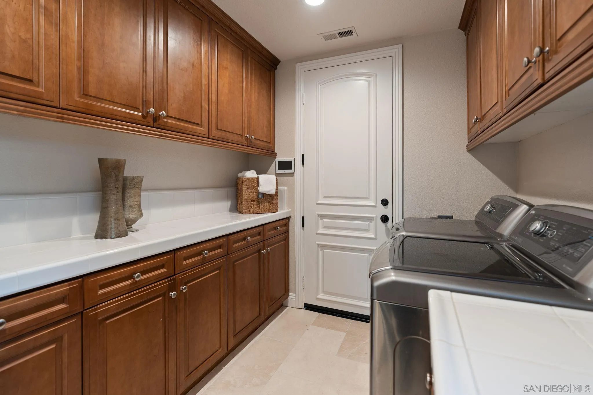 15583 Rising River Place South San Diego, CA 92127 - Photo 37 of 61 a kitchen with sink cabinets and stove