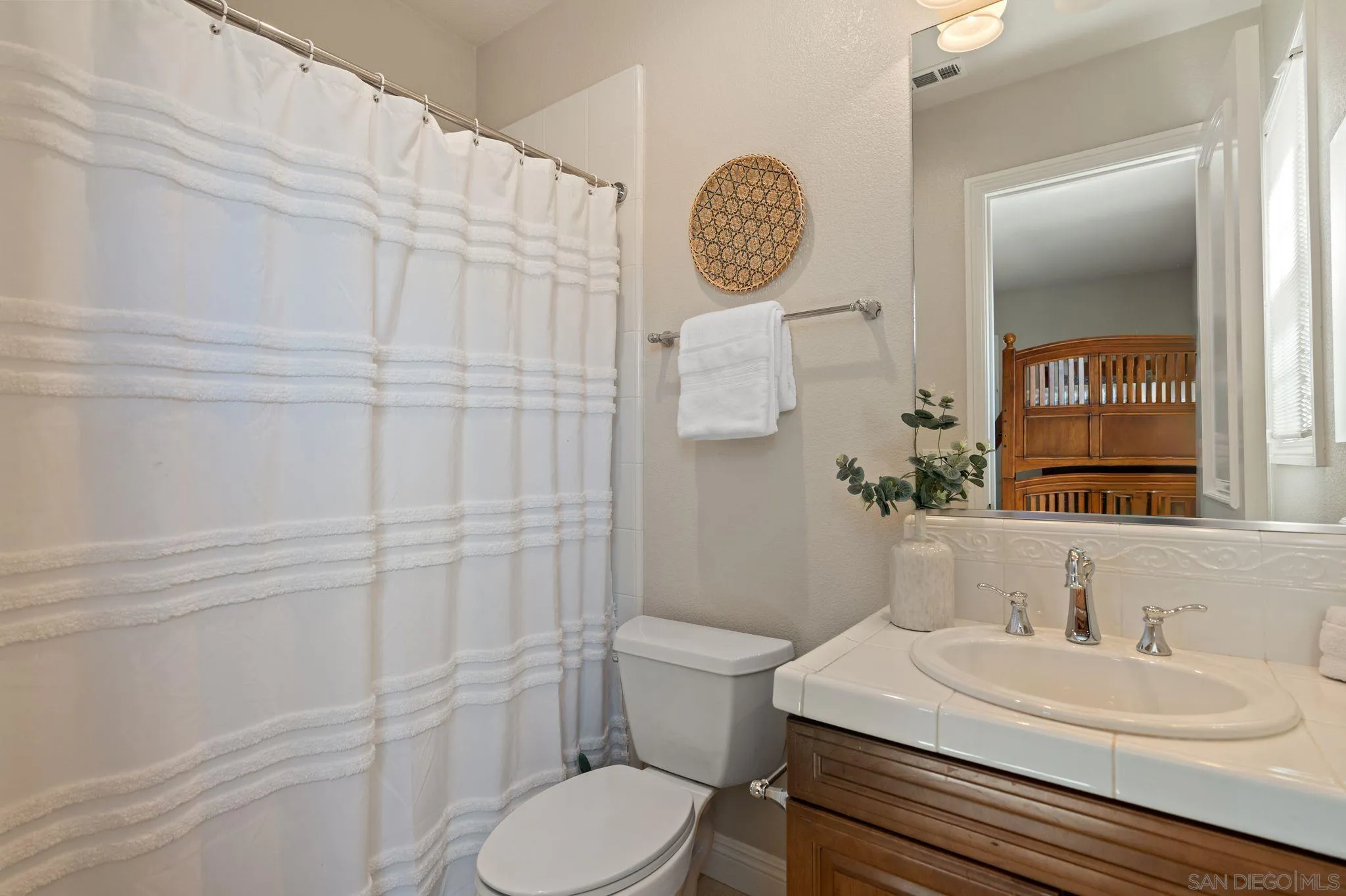 15583 Rising River Place South San Diego, CA 92127 - Photo 50 of 61 a bathroom with a toilet sink vanity and mirror