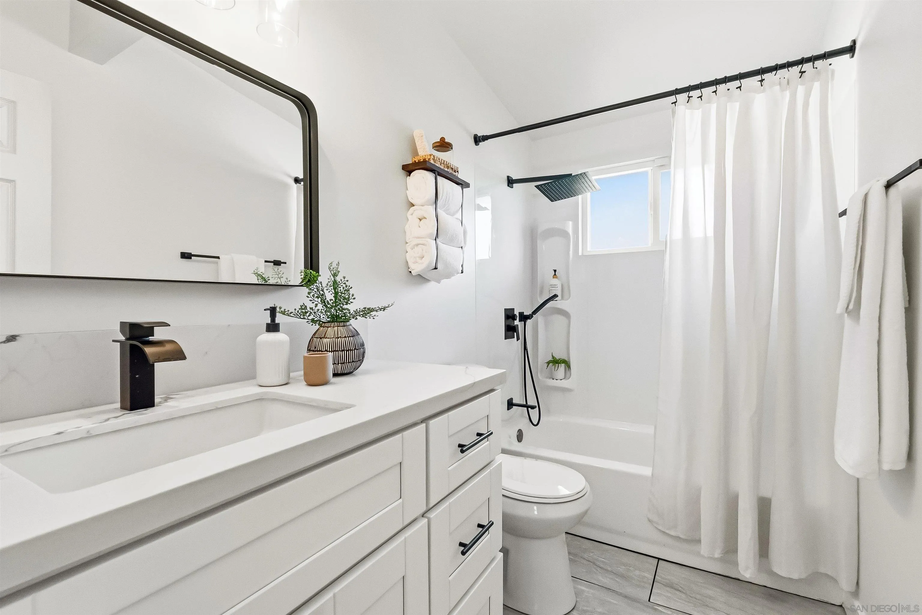 9844 Arapaho Street Spring Valley, CA 91977 - Photo 14 of 29 a bathroom with a granite countertop sink a toilet and a mirror