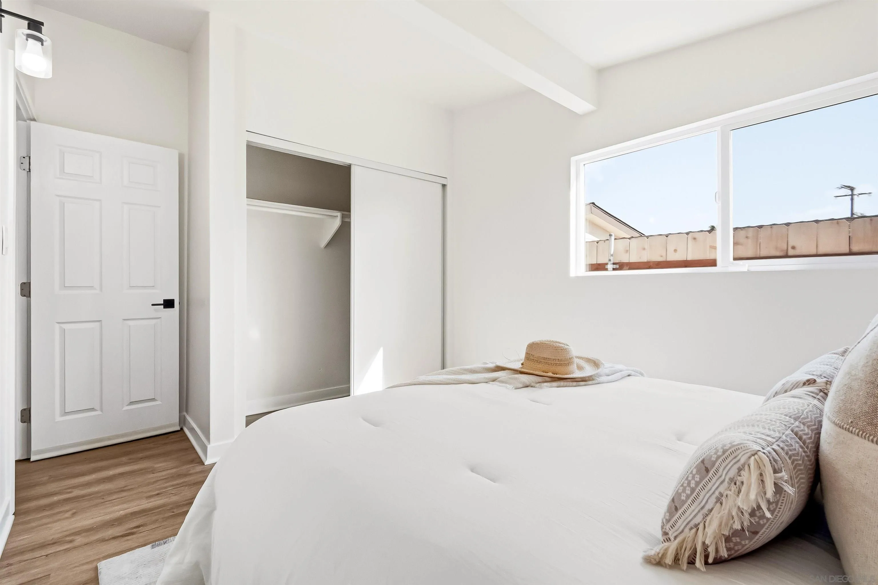 9844 Arapaho Street Spring Valley, CA 91977 - Photo 19 of 29 a bedroom with a bed and wooden floor