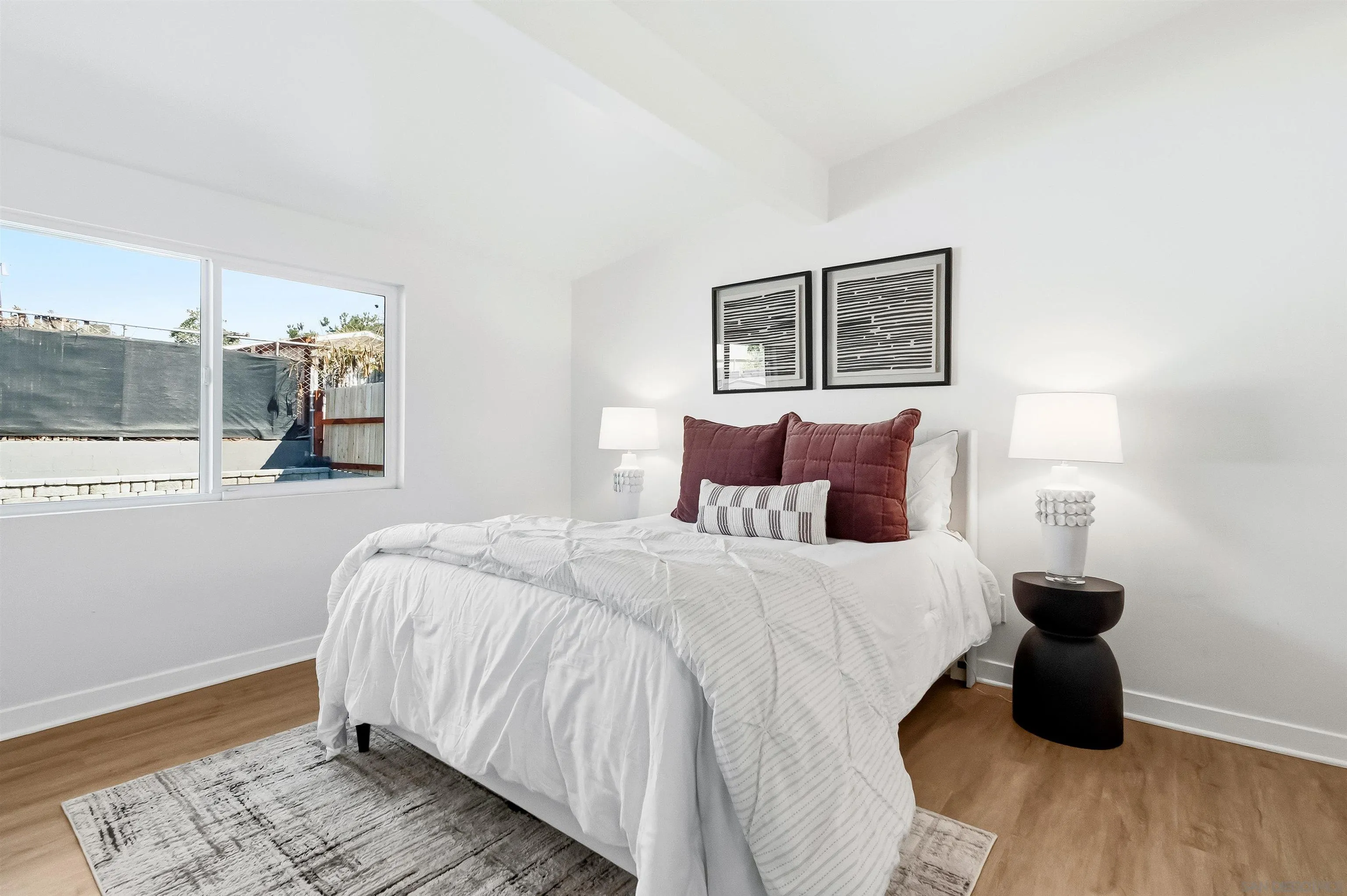 9844 Arapaho Street Spring Valley, CA 91977 - Photo 20 of 29 a bedroom with a bed and wooden floor