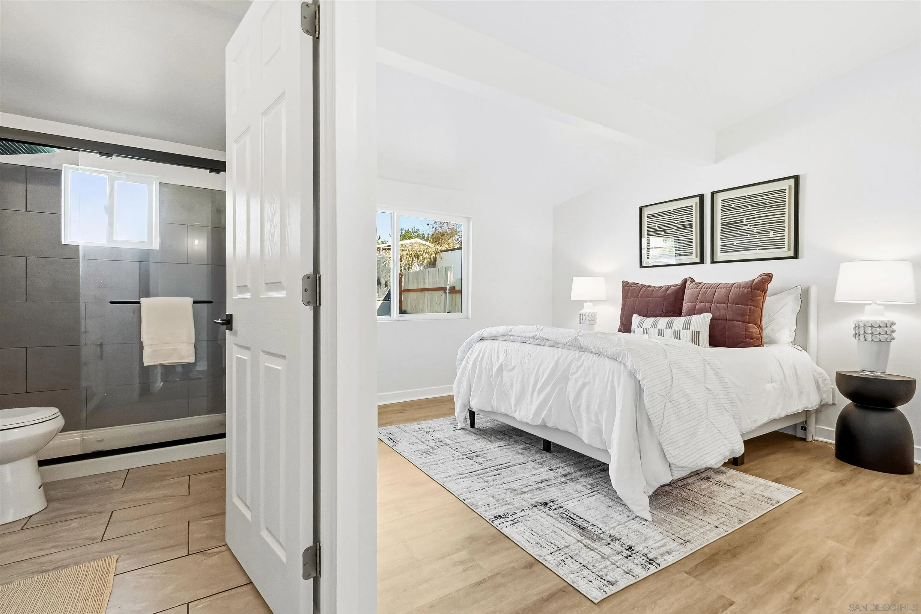 9844 Arapaho Street Spring Valley, CA 91977 - Photo 21 of 29 a bedroom with a bed and glass door