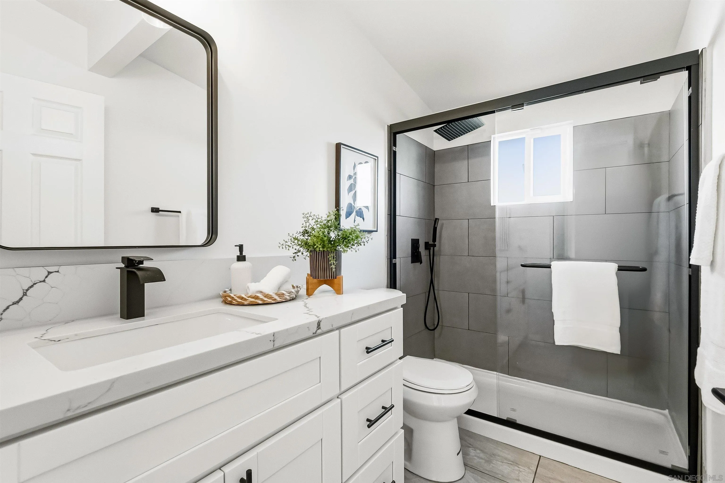 9844 Arapaho Street Spring Valley, CA 91977 - Photo 22 of 29 a bathroom with a granite countertop sink a toilet a mirror and shower