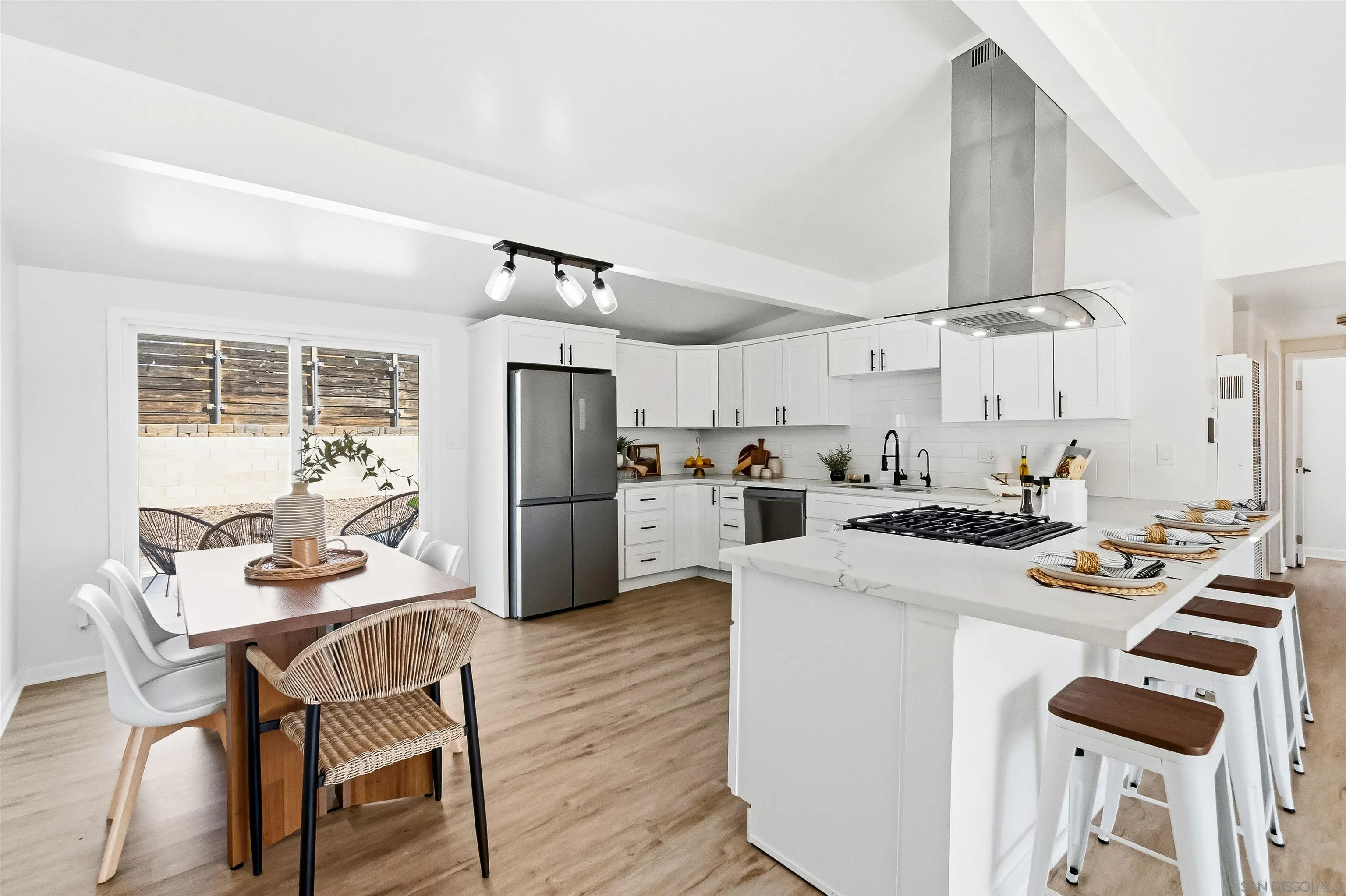 9844 Arapaho Street Spring Valley, CA 91977 - Photo 6 of 29 a kitchen with a table chairs stove and refrigerator