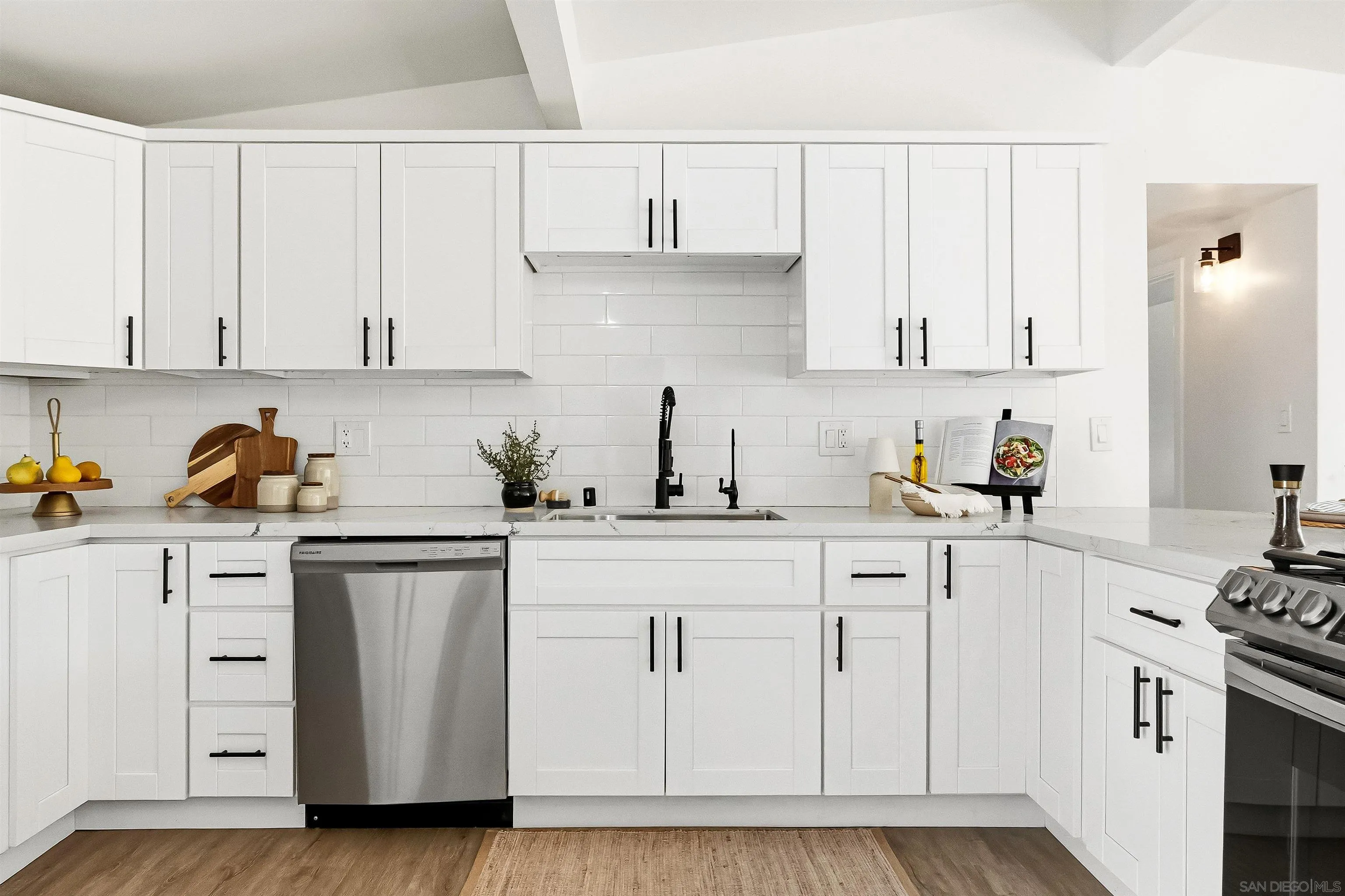 9844 Arapaho Street Spring Valley, CA 91977 - Photo 7 of 29 a kitchen with white cabinets and white appliances