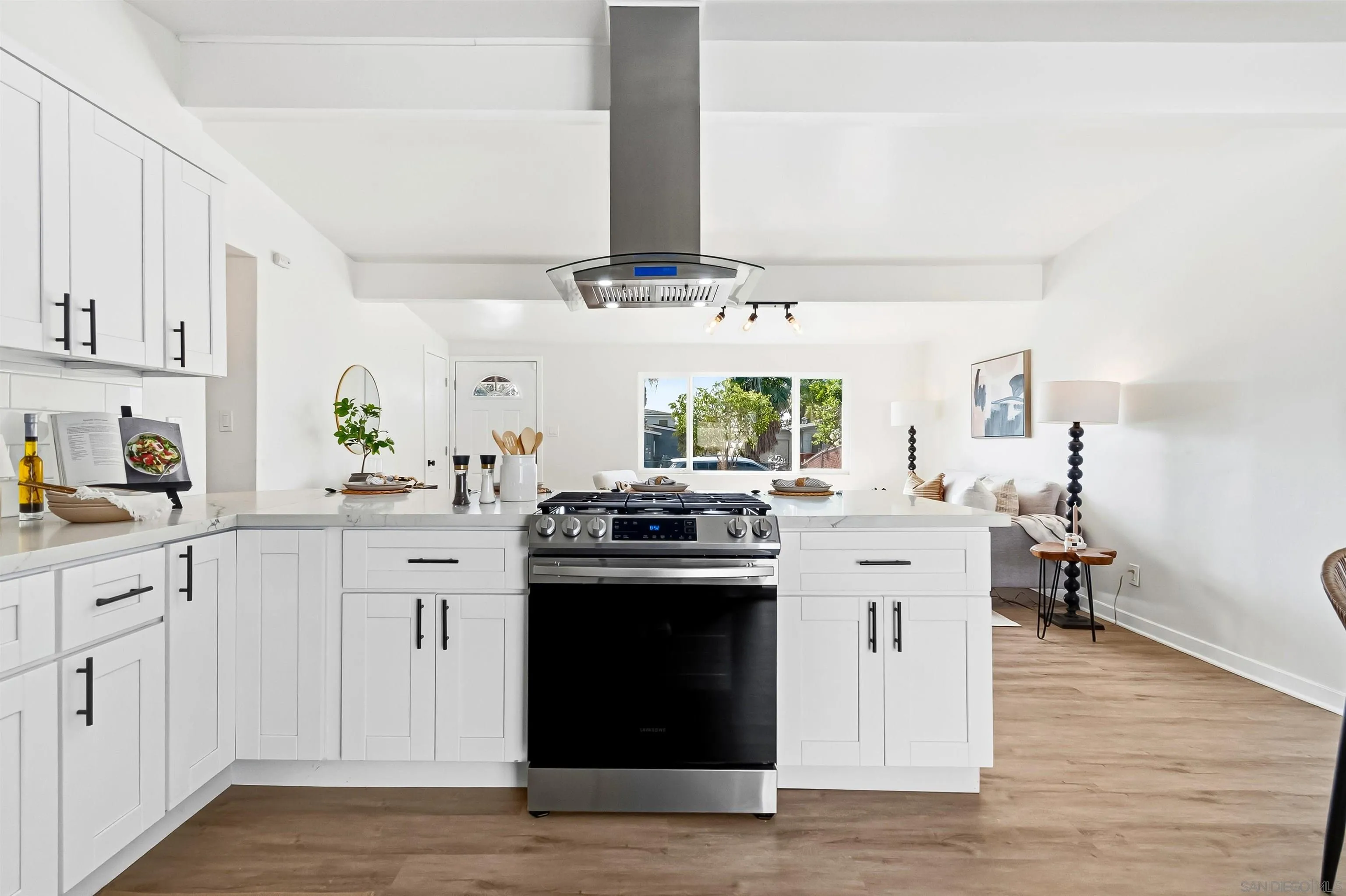 9844 Arapaho Street Spring Valley, CA 91977 - Photo 8 of 29 a kitchen with stainless steel appliances a sink stove and cabinets
