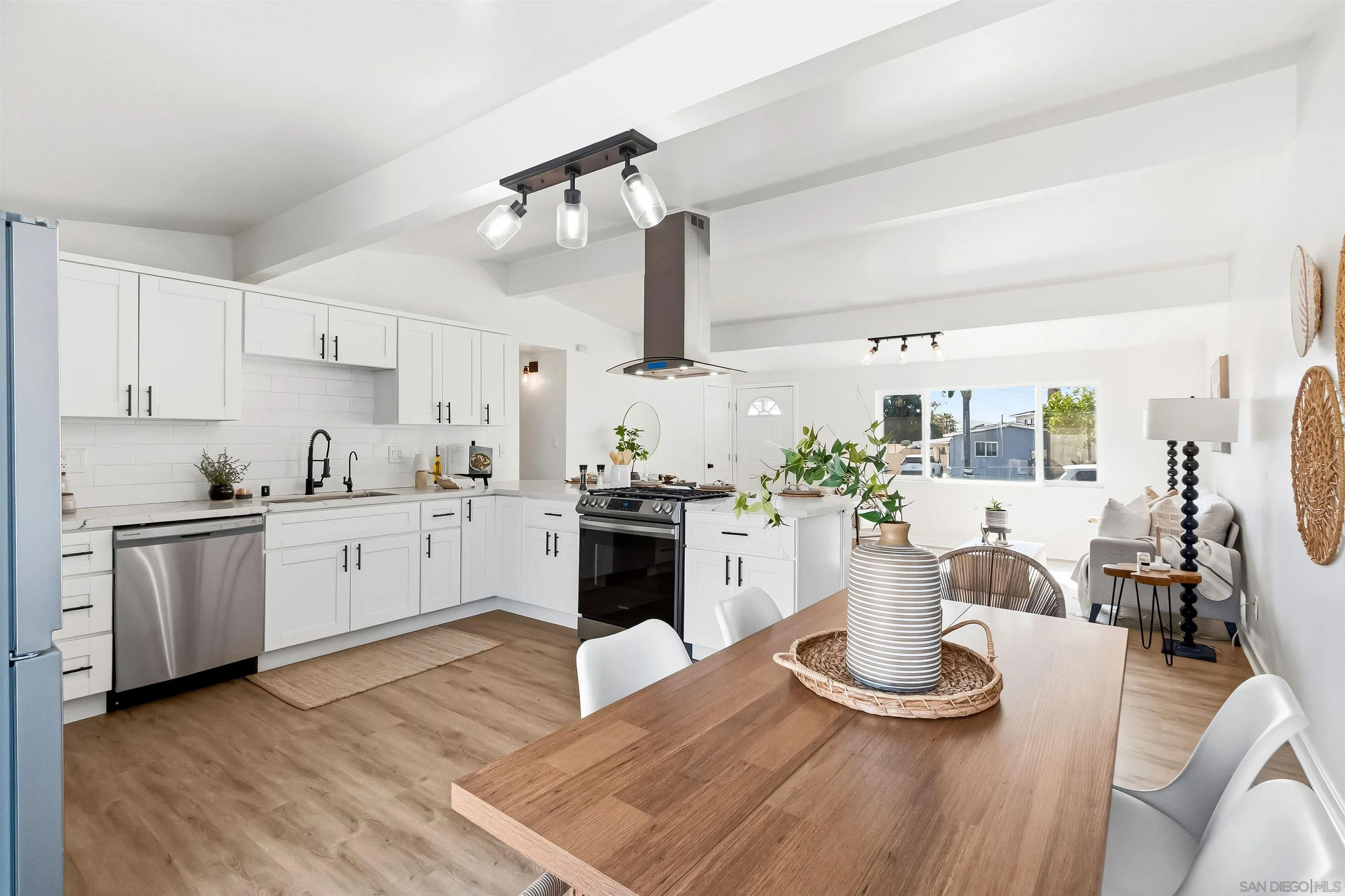 9844 Arapaho Street Spring Valley, CA 91977 - Photo 9 of 29 a kitchen with a stove and white cabinets
