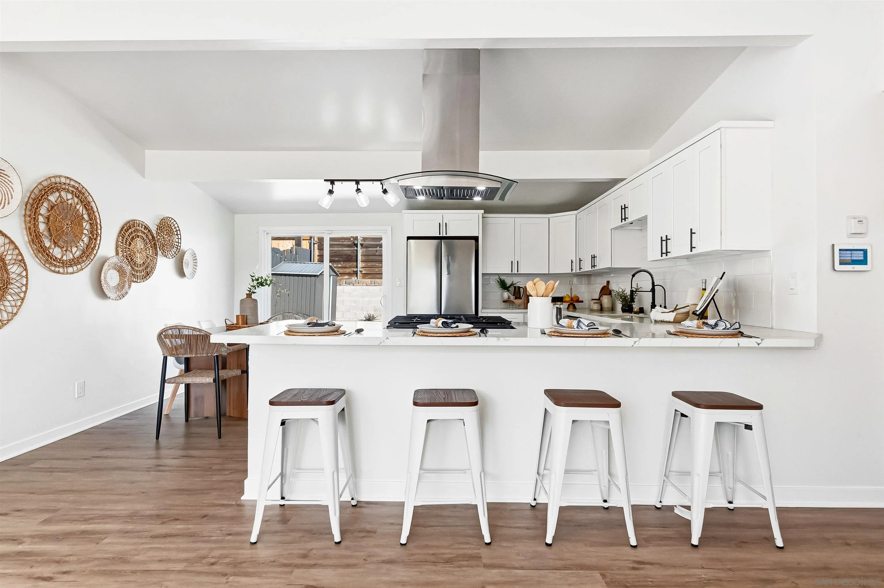 9844 Arapaho Street Spring Valley, CA 91977 - Photo 10 of 29 a kitchen with stainless steel appliances granite countertop a kitchen island a stove a table and chairs