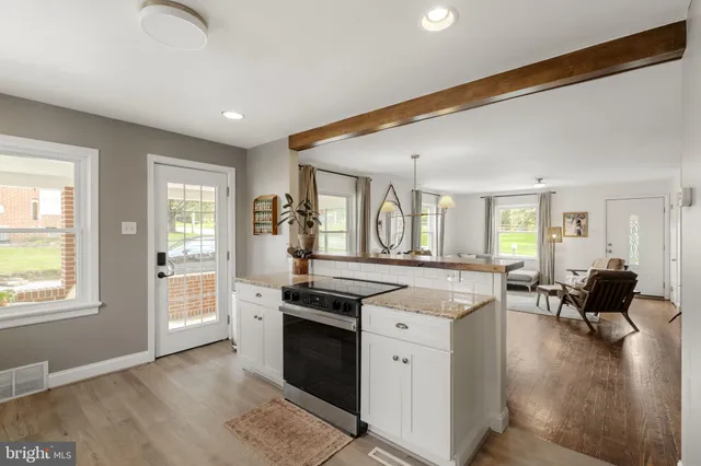 a kitchen with granite countertop a stove and a sink