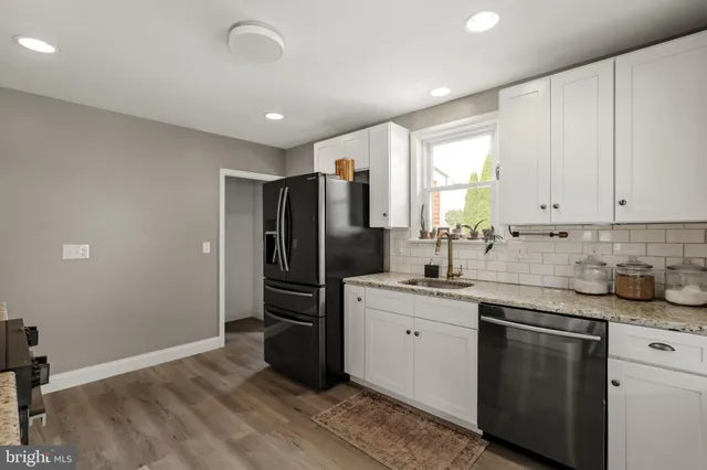 a kitchen with stainless steel appliances granite countertop a refrigerator sink and cabinets