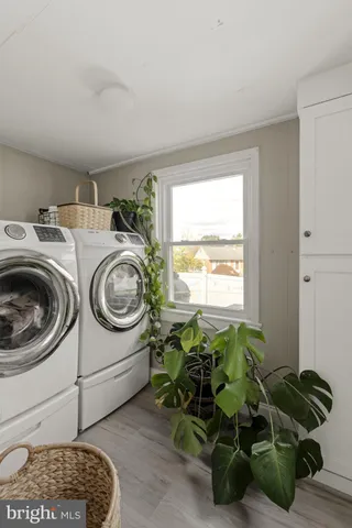 a utility room with sink dryer and washer