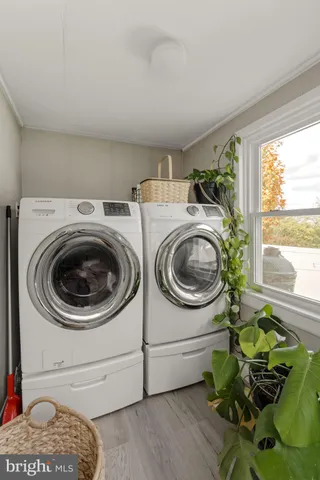 a bedroom with a bed a chair and a fireplace