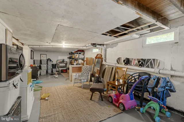 a building outdoor space with patio furniture and a garden