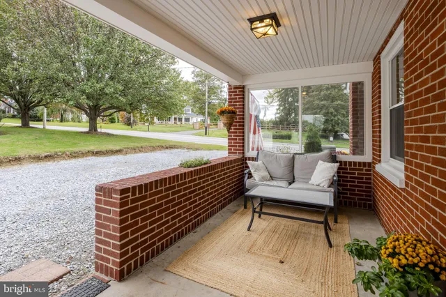 a view of a room with a table and chairs