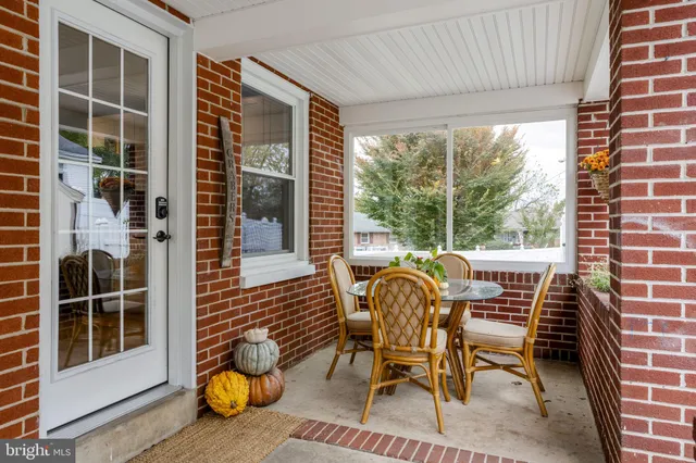 a view of a house with backyard porch and sitting area