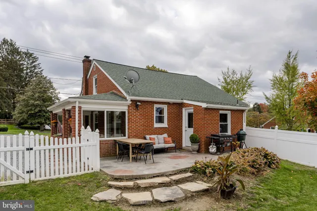 a front view of house with yard and outdoor seating