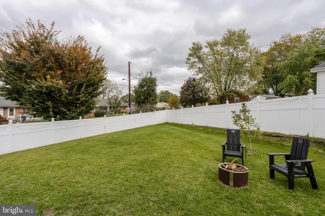 a view of a house with yard and sitting area