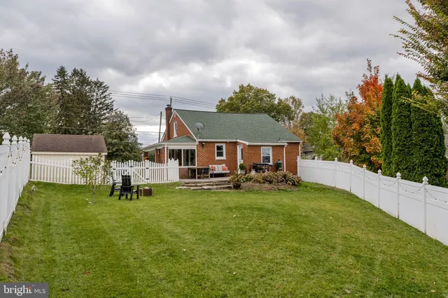 an aerial view of a house with swimming pool garden and patio