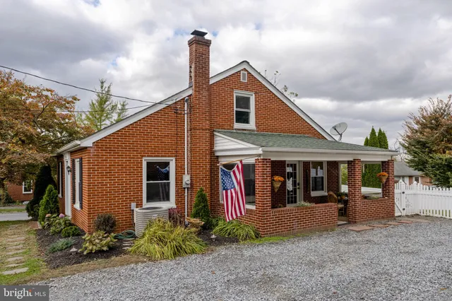a view of a house with large windows and plants