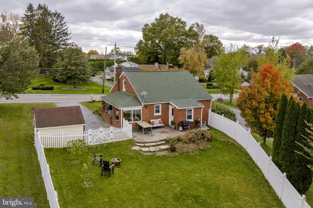 an aerial view of a house with outdoor space swimming pool and mountains