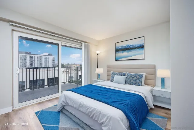 a bedroom with a large bed and a large window