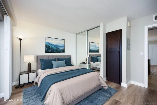 a bedroom with a bed and a mirror