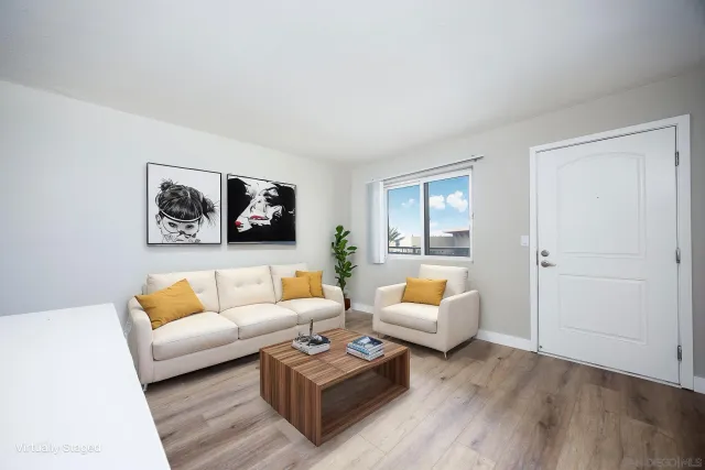 a living room with furniture and wooden floor