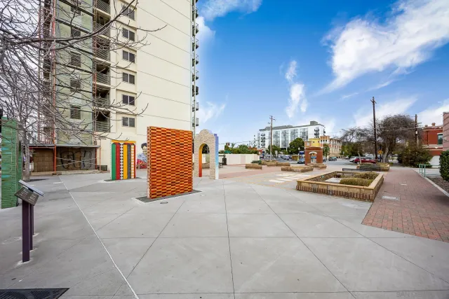 a view of a room with gym equipment and a chandelier