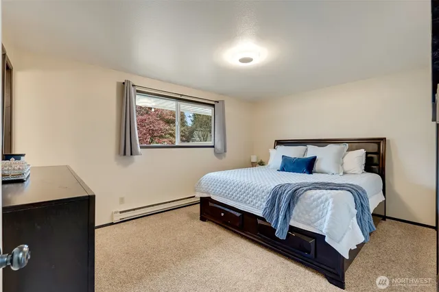 a bedroom with a bed and a dresser