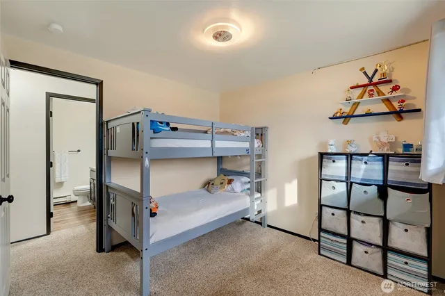 a bathroom with a granite countertop sink a toilet and a mirror
