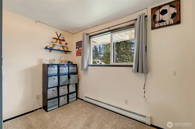 a view of a small space with wooden floor and a window