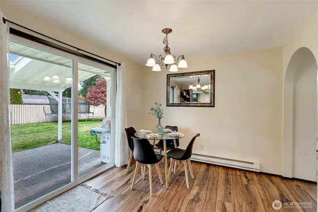 a view of a dining room with furniture and wooden floor