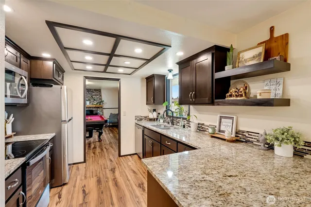 a kitchen with sink stove and cabinets
