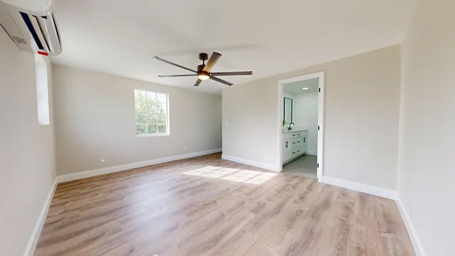 wooden floor in an empty room with a window