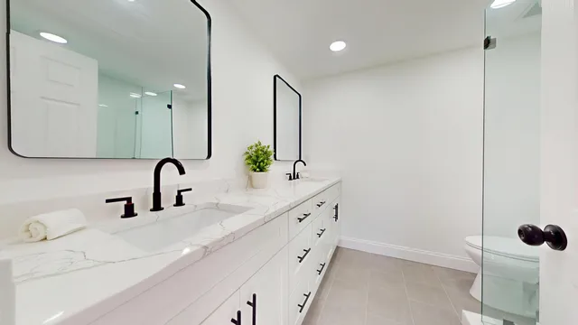 a bathroom with a double vanity sink and mirror