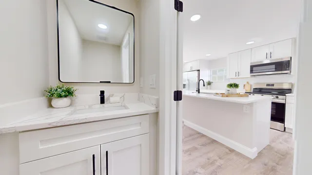 a kitchen with kitchen island white cabinets and white appliances