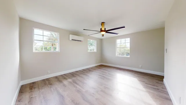 wooden floor in an empty room with a window