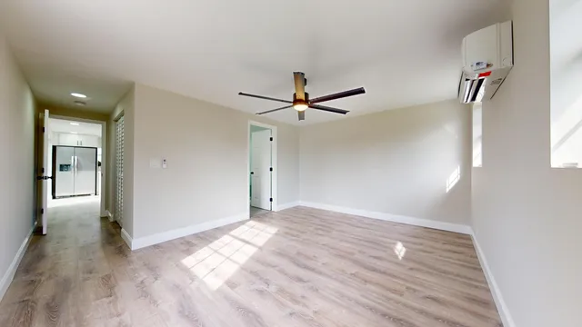 wooden floor in an empty room with a window