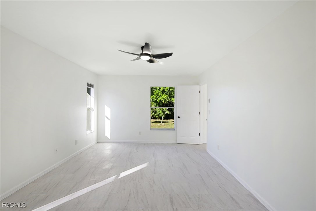2519 Southwest 30th Street Cape Coral, FL 33914 - Photo 13 of 23 an empty room with windows and fan