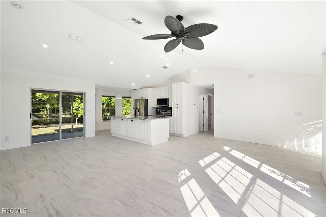 2519 Southwest 30th Street Cape Coral, FL 33914 - Photo 5 of 23 a view of an empty room with a window and kitchen view