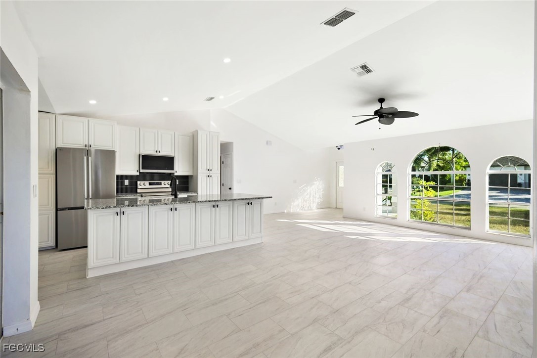 2519 Southwest 30th Street Cape Coral, FL 33914 - Photo 6 of 23 a view of kitchen with refrigerator and microwave