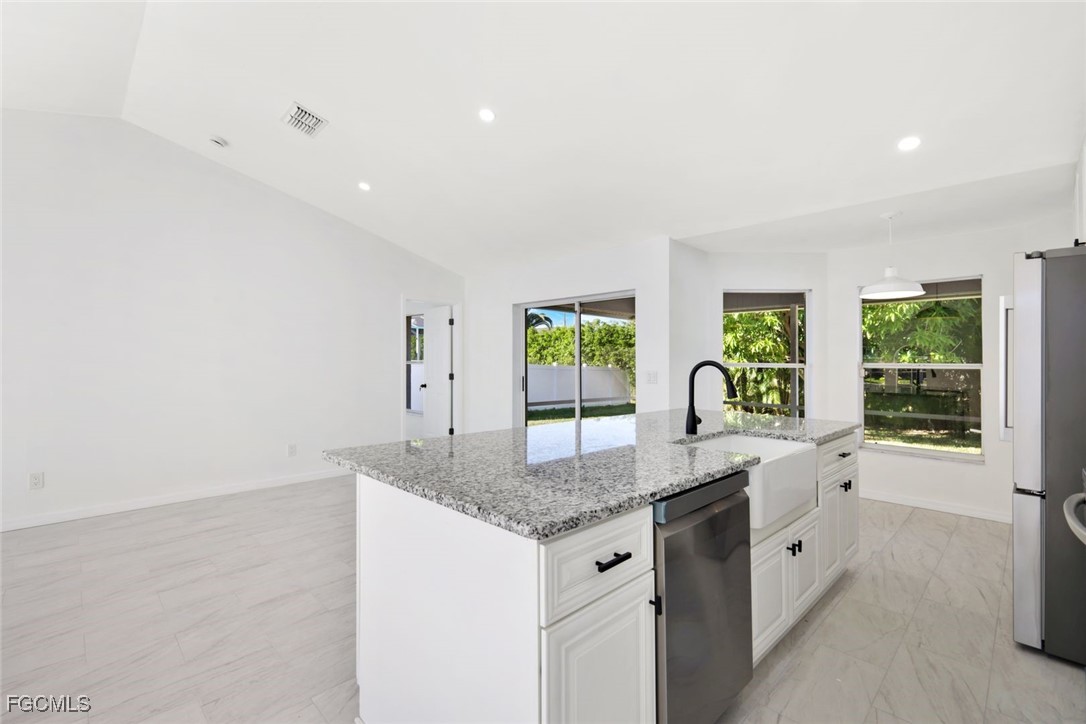 2519 Southwest 30th Street Cape Coral, FL 33914 - Photo 8 of 23 a kitchen with granite countertop a sink and a window