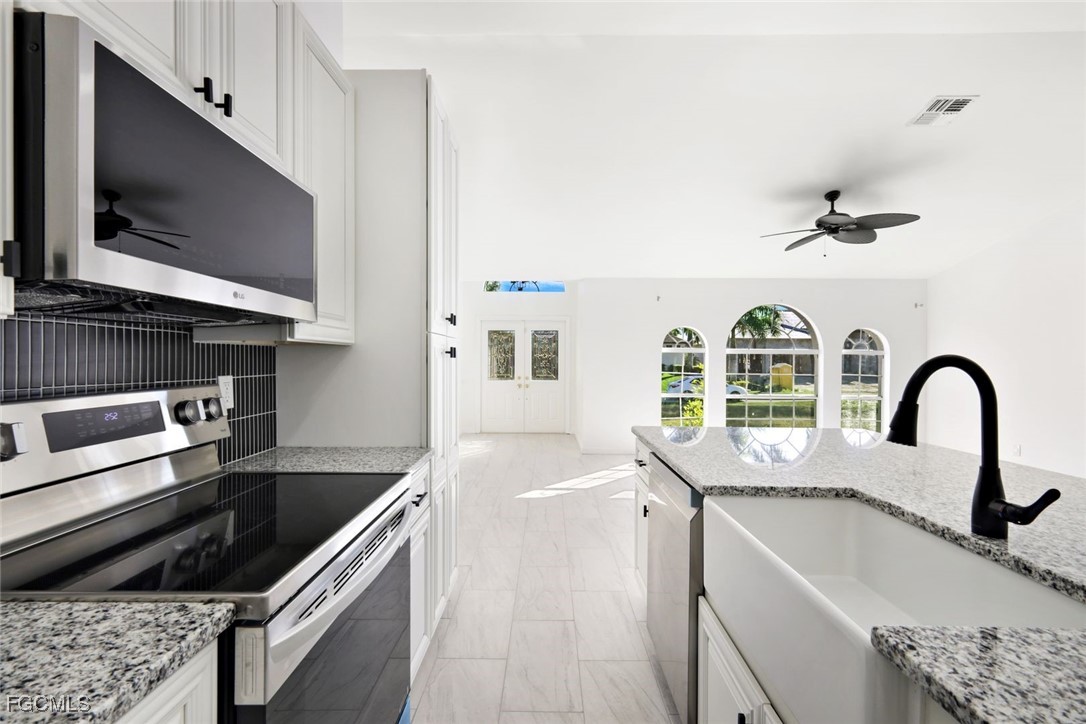 2519 Southwest 30th Street Cape Coral, FL 33914 - Photo 9 of 23 a kitchen with a stove and a sink