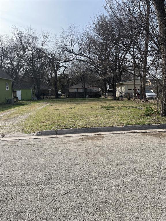 605 South Rusk Street Gainesville, TX 76240 - Photo 2 of 5 a front view of a house with a yard and trees