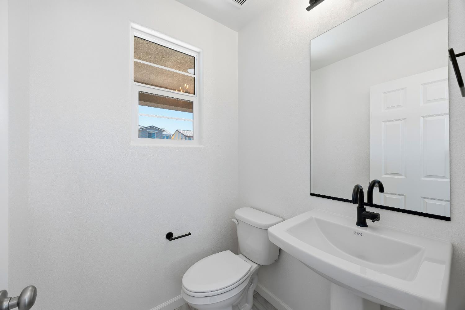 4401 Canyon Coral Way Rancho Cordova, CA 95742 - Photo 13 of 23 a bathroom with a sink a toilet and a mirror